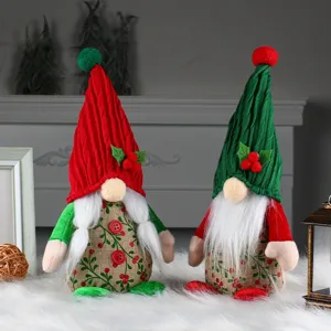 Set of 2 handmade Christmas gnomes with cherry pattern hats for festive table decor.