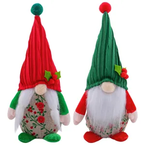 Pair of cute Christmas gnomes with knit hats and berry patterns for holiday decor
