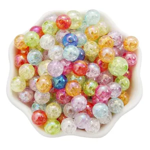 Macro view of various colorful cracked acrylic AB bubble beads in a white flower ceramic bowl