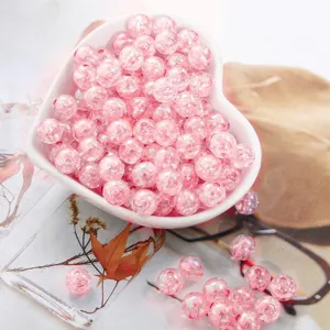 Close-up of pink acrylic crackle bubble beads in a heart bowl for DIY jewelry