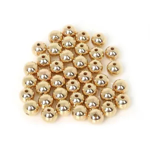 Detailed macro view of shiny golden round CCB spacer beads for DIY handmade jewelry crafts