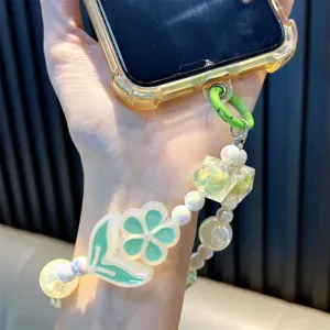 Luminous flower beaded phone strap with pearl accents attached to a clear phone case.