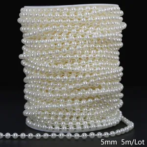 Detailed macro view of 5mm cream white ABS faux pearl bead chain wound on spool