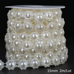 Close-up detail of 15mm cream white flower-shaped ABS pearl bead chain on a spool