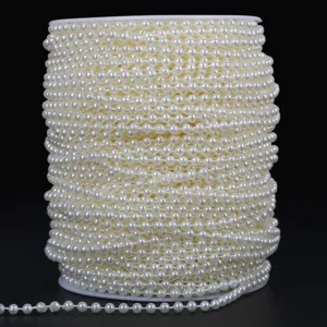 Off-white ABS imitation pearl chain on a spool for DIY wedding floral decorations.