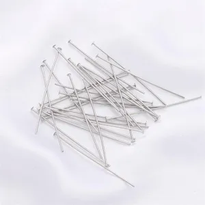 Macro view of several silver flat head T-pins jewelry making materials for DIY craft projects