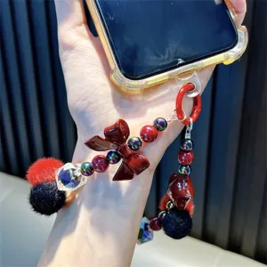 Kralen telefoonketting met rode bontbal en strik voor tassen en mobiele telefoons