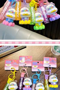 Close-up of colorful Little Buddha Duck keychains with matching wristbands and packaging