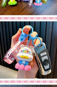 Close-up detail of cute cartoon duck keychain with pink lotus base and Hello Duck strap