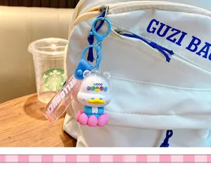 Close-up of a cartoon duck keychain charm hanging on a white backpack zipper