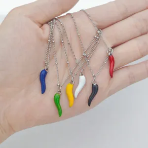 Detail shot of six colorful enamel chili pepper pendants on stainless steel chains.