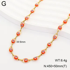 Close-up of golden stainless steel necklace with orange evil eye beads
