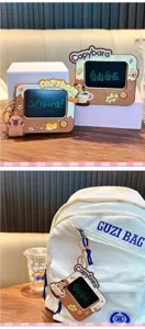 Detailed view of Capybara-themed mini electronic graffiti board keychain hanging on a bag