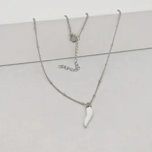 Detail showing a minimalist white enamel chili pendant on a stainless steel bead chain.