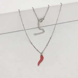 Detailed shot of silver stainless steel necklace with red enamel chili pepper pendant