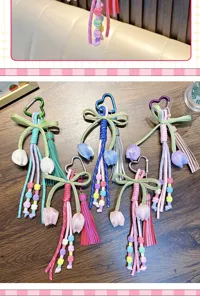 Handmade bohemian tulip tassel keychains with heart carabiners in colorful woven designs