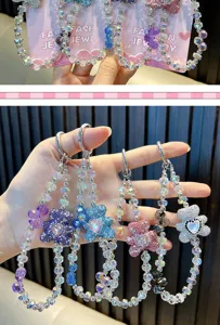 Detail showing multi-colored beaded phone straps with sparkling rhinestone heart bear charms