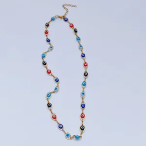 Detail view of multicolored evil eye beads on a gold-plated stainless steel chain