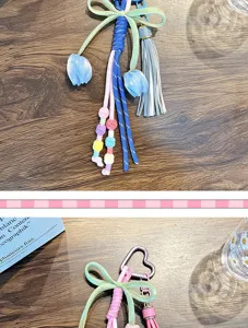 Detailed view of bohemian braided tulip keychain with decorative tassels and ribbon bow