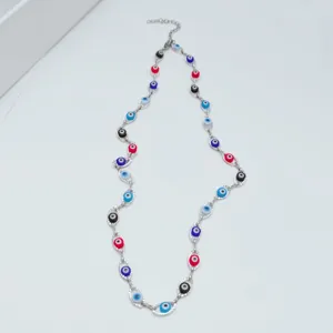 Close-up of a stainless steel necklace featuring colorful evil eye beads on white background
