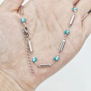 Detailed close-up view of a stainless steel evil eye necklace with colorful enamel charms
