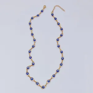 Detailed view of gold stainless steel necklace with blue evil eye beads for protection