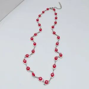 Stainless steel evil eye necklace with vibrant red beads on a silver chain detail view