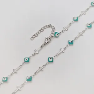 Close-up of stainless steel necklace with turquoise evil eye beads and small crosses