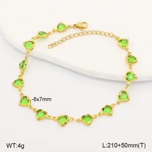 Detailed view of a gold heart anklet with green stones, showing size and weight.