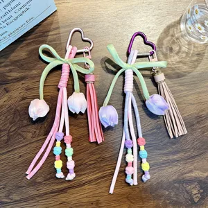Bohemian hand-woven tulip flower keychain with tassel and heart-shaped carabiner.