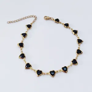 Elegant gold stainless steel anklet with black heart-shaped crystal charms detail