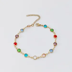 Close-up view of a gold-plated stainless steel anklet with vibrant colorful glass circles