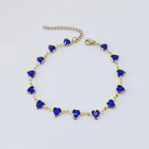 Detailed view of gold-tone stainless steel anklet with blue heart-shaped stones