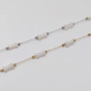 Detail showing stainless steel bamboo chains with white acrylic beads for DIY jewelry making