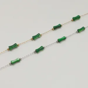 Detail of stainless steel chains with green bamboo beads for handmade jewelry making