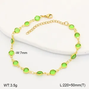 Detail of gold stainless steel anklet with circular green glass inserts and lobster clasp