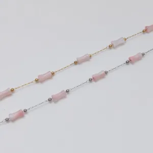 Detailed view of stainless steel bamboo joint chains with pink beads for jewelry making