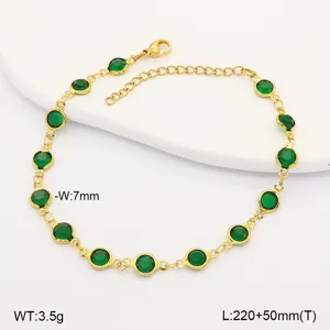 Detail view of a gold stainless steel anklet with vibrant green circular glass stones.