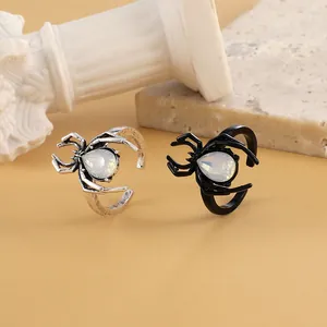 Gothic spider adjustable open rings in black and silver finishes with teardrop gems
