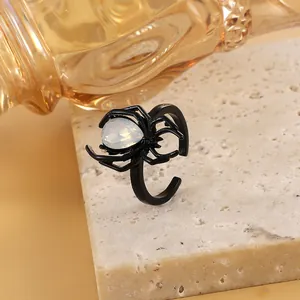 Detailed close-up of gothic black spider open ring with a pear-shaped white stone
