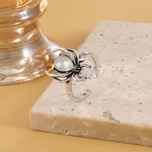 Macro detail of an antique silver gothic spider open ring with white opal stone