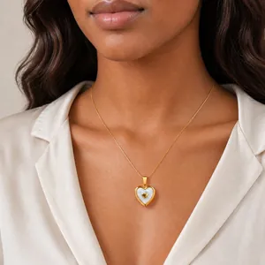 Detailed view of gold-plated stainless steel heart locket necklace on female model