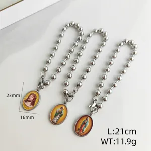 Detail view of three stainless steel ball chain bracelets featuring religious oval pendants