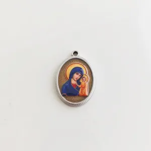 Detailed close-up of a religious Virgin Mary and Child icon on an oval steel pendant