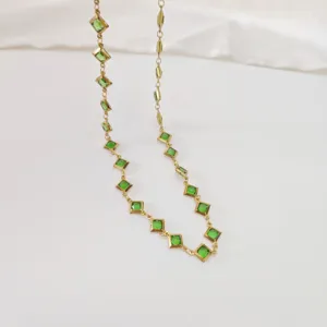 Close-up detail of the green square sugar crystals on a gold stainless steel chain