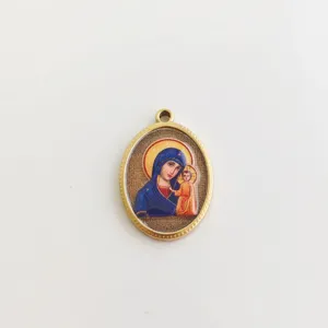 Close-up of vintage oval stainless steel pendant with religious Virgin Mary icon