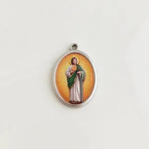 Detailed view of an oval stainless steel religious pendant with colorful saint imagery