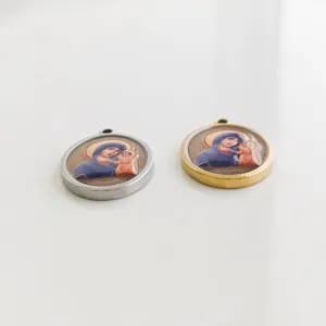 Detail view of round stainless steel religious pendants with Madonna and Child icon
