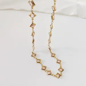 Detailed close-up view of a gold stainless steel necklace featuring elegant champagne rhombus stones