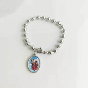 Close-up of stainless steel bead bracelet with St. Christopher religious pendant